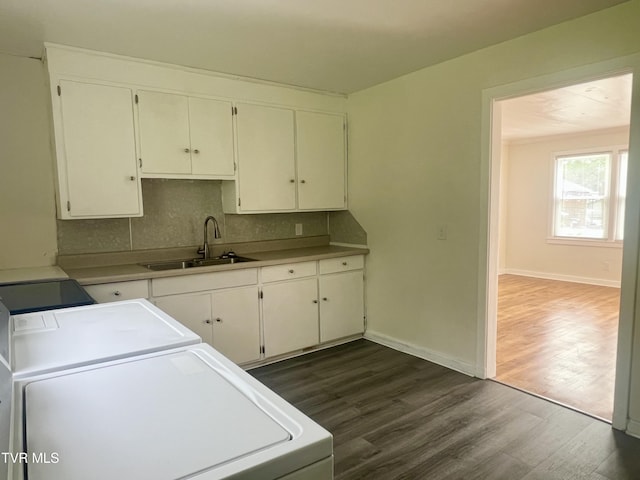 1001 Gibson Mill Rd, Kingsport, TN 37660 - clothes washing area featuring separate washer and dryer, baseboards, dark wood-style floors, and a sink