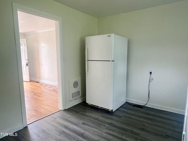 1001 Gibson Mill Rd, Kingsport, TN 37660 - interior space featuring heating unit, baseboards, freestanding refrigerator, and dark wood finished floors