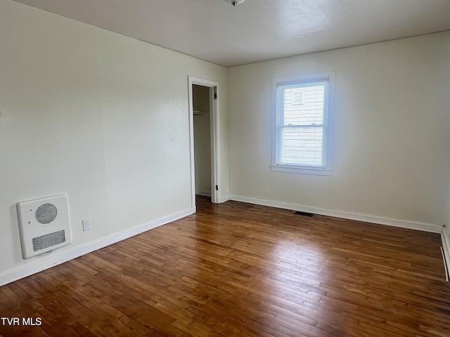 1001 Gibson Mill Rd, Kingsport, TN 37660 - spare room featuring wood-type flooring, baseboards, heating unit, and visible vents