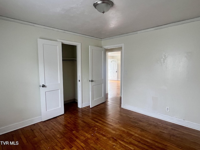 1001 Gibson Mill Rd, Kingsport, TN 37660 - unfurnished bedroom with baseboards, crown molding, wood finished floors, and a closet