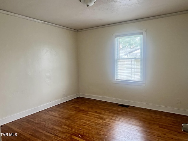 1001 Gibson Mill Rd, Kingsport, TN 37660 - spare room with crown molding, baseboards, wood finished floors, and visible vents