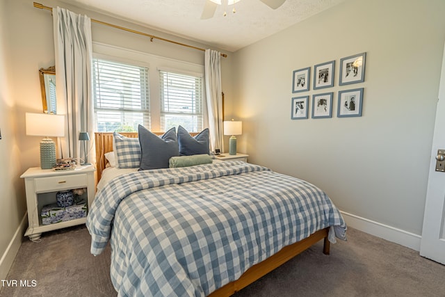 carpeted bedroom featuring baseboards, a ceiling fan, and a textured ceiling