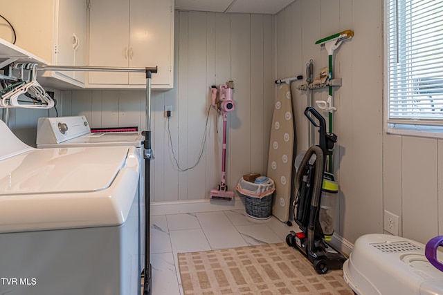 clothes washing area with tile patterned flooring, cabinet space, and washing machine and dryer