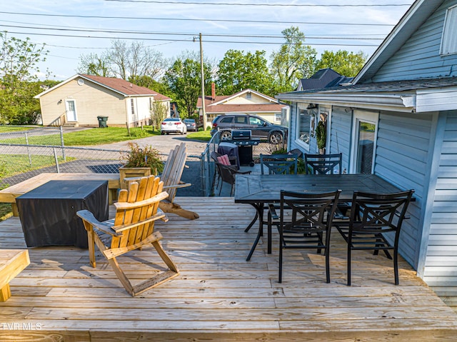 deck featuring fence and outdoor dining space