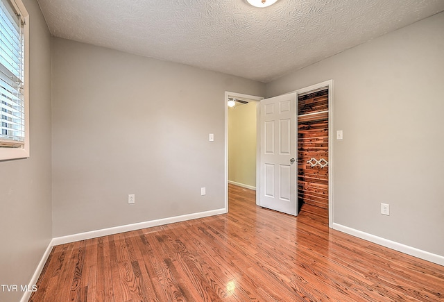 unfurnished bedroom with a closet, light wood-type flooring, and baseboards