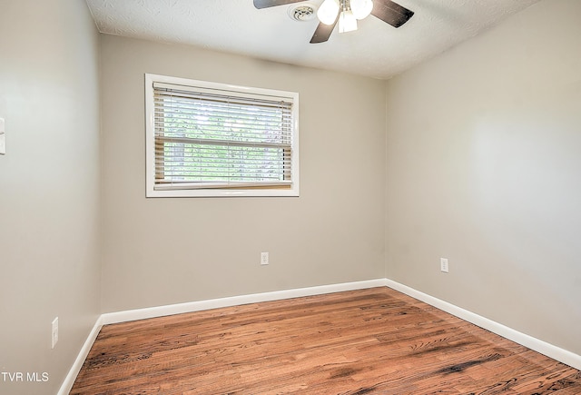 unfurnished room with ceiling fan, baseboards, and wood finished floors