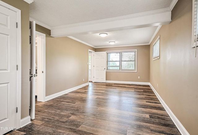 empty room with a textured ceiling, baseboards, ornamental molding, and dark wood-style floors