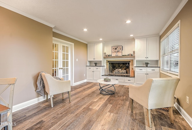 sitting room featuring baseboards, ornamental molding, french doors, and wood finished floors