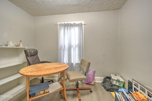 921 E Sevier Ave, Kingsport, TN 37660 - dining area featuring baseboards, a textured ceiling, and wood finished floors
