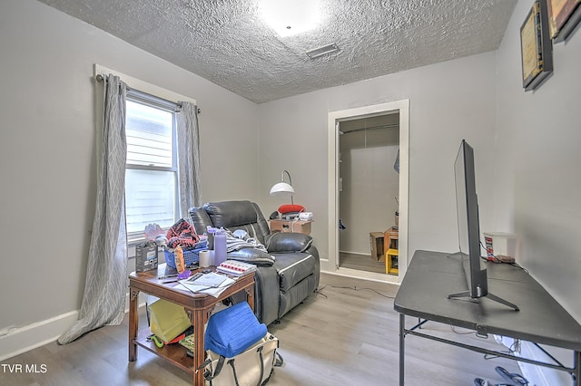 921 E Sevier Ave, Kingsport, TN 37660 - office space with baseboards, light wood-type flooring, and a textured ceiling