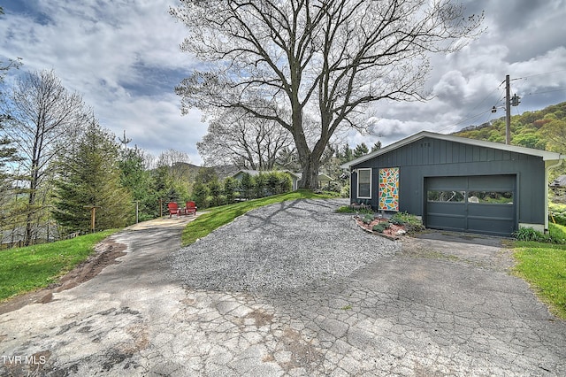 190 Roanwood Rd, Roan Mountain, TN 37687 - exterior space featuring aphalt driveway, an outbuilding, and a garage