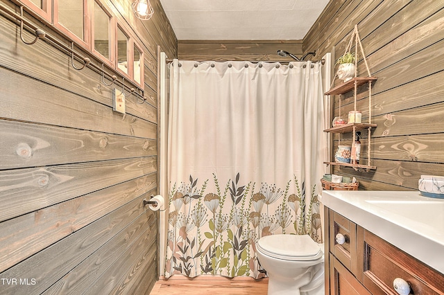 190 Roanwood Rd, Roan Mountain, TN 37687 - bathroom featuring a shower with curtain, wood walls, vanity, and toilet