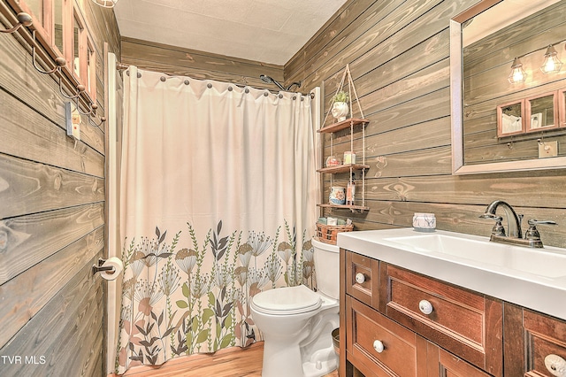 190 Roanwood Rd, Roan Mountain, TN 37687 - full bathroom with curtained shower, wood finished floors, vanity, toilet, and wooden walls
