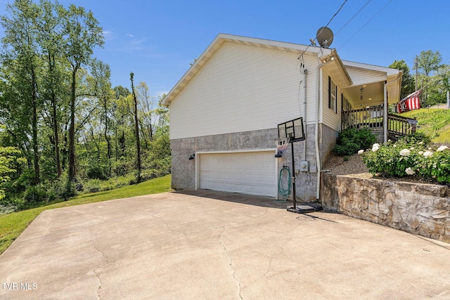 view of side of home featuring a garage and driveway