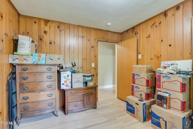 interior space with wooden walls and light wood-style floors