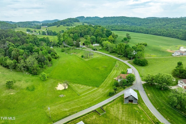 birds eye view of property with a rural view and a view of trees