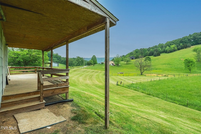 view of yard featuring a wooden deck and a rural view