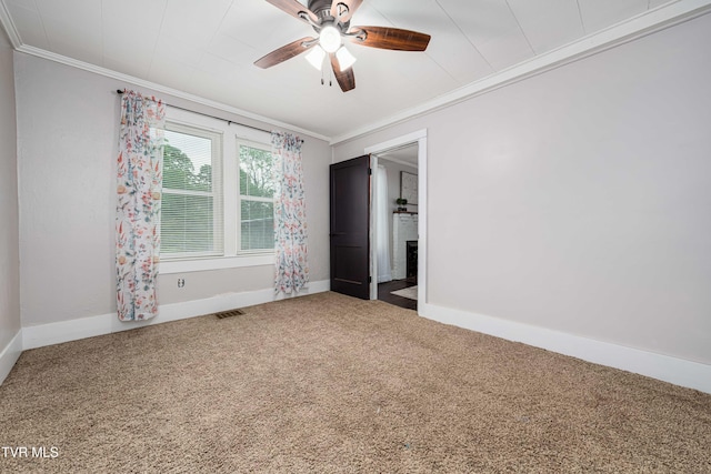 unfurnished bedroom featuring ornamental molding, carpet floors, baseboards, and visible vents