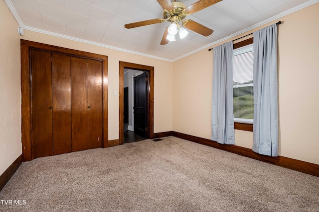 unfurnished bedroom featuring carpet, a closet, and ornamental molding
