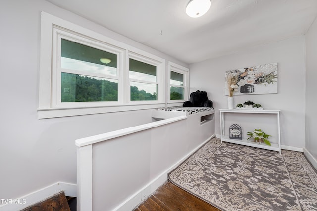 interior space featuring baseboards and wood finished floors