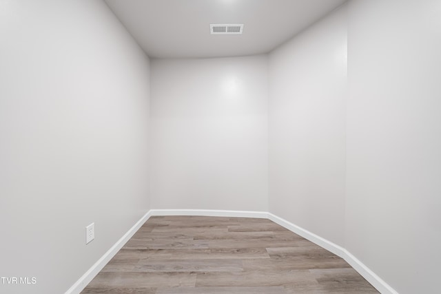 unfurnished room with baseboards, light wood-style floors, and visible vents