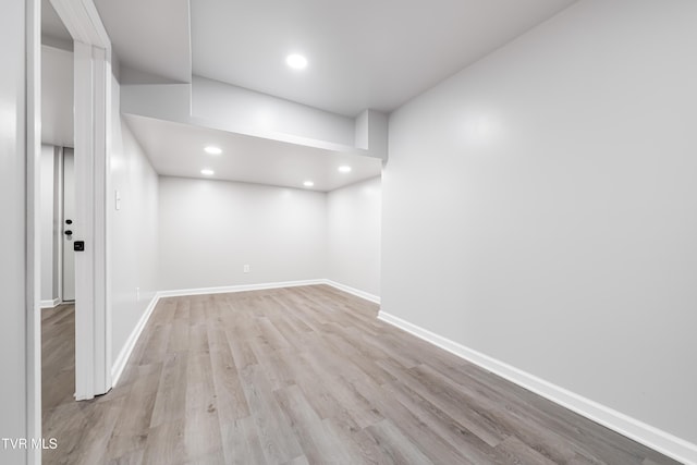 below grade area featuring baseboards, recessed lighting, and wood finished floors