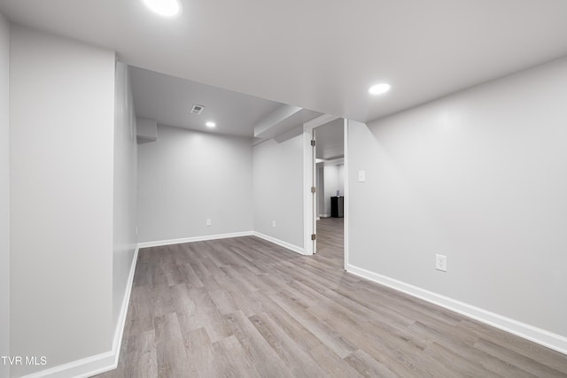 finished below grade area with visible vents, wood finished floors, baseboards, and recessed lighting