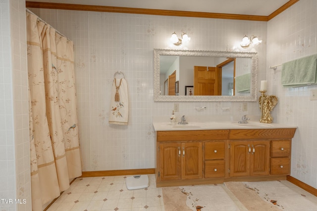 full bath with double vanity, baseboards, ornamental molding, and a sink