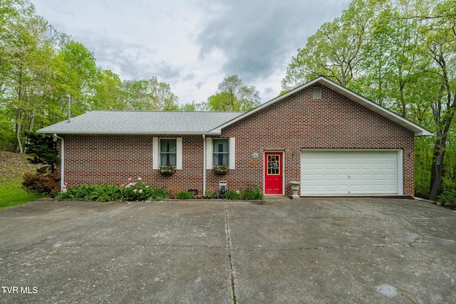 single story home with driveway, a shingled roof, brick siding, and an attached garage