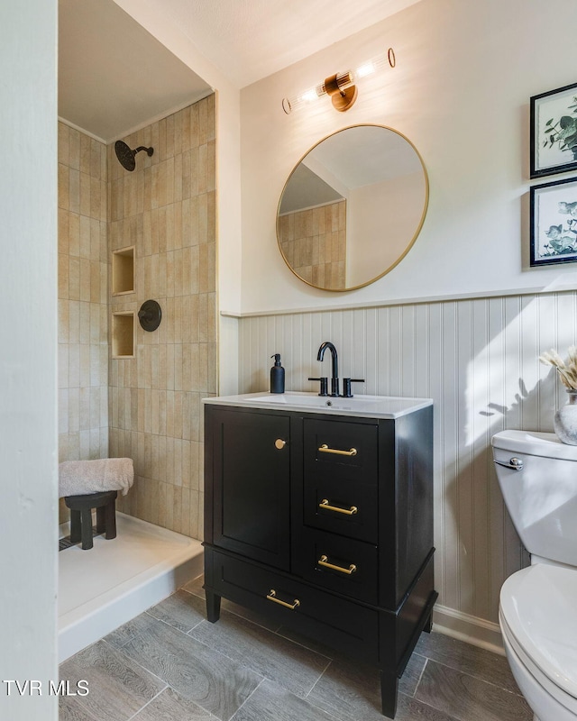 541 Vance Dr, Bristol, TN 37620 - bathroom with toilet, a tile shower, vanity, and a wainscoted wall