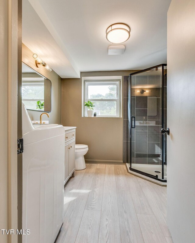 541 Vance Dr, Bristol, TN 37620 - bathroom featuring wood finished floors, a stall shower, washer / dryer, vanity, and toilet