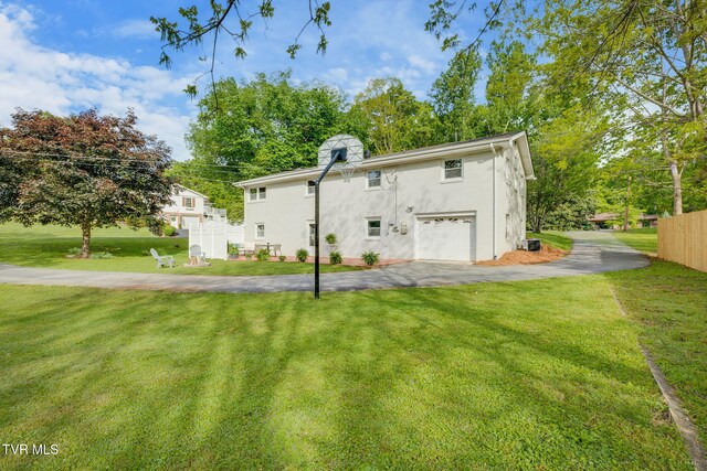 541 Vance Dr, Bristol, TN 37620 - rear view of property featuring asphalt driveway, stucco siding, and a garage