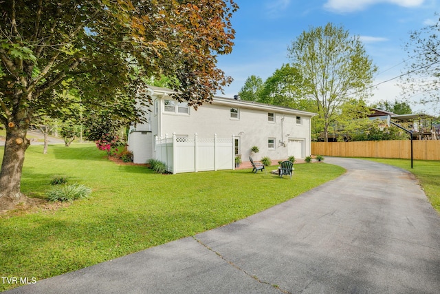 541 Vance Dr, Bristol, TN 37620 - back of house featuring driveway, a garage, and stucco siding
