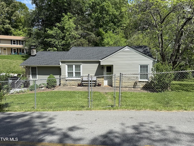 view of front of home with a chimney, a fenced front yard, roof with shingles, and a front lawn
