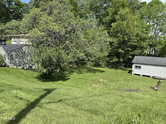 view of yard with an outdoor structure and fence