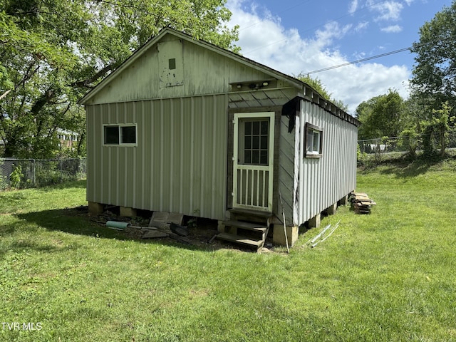 view of outbuilding featuring fence and entry steps