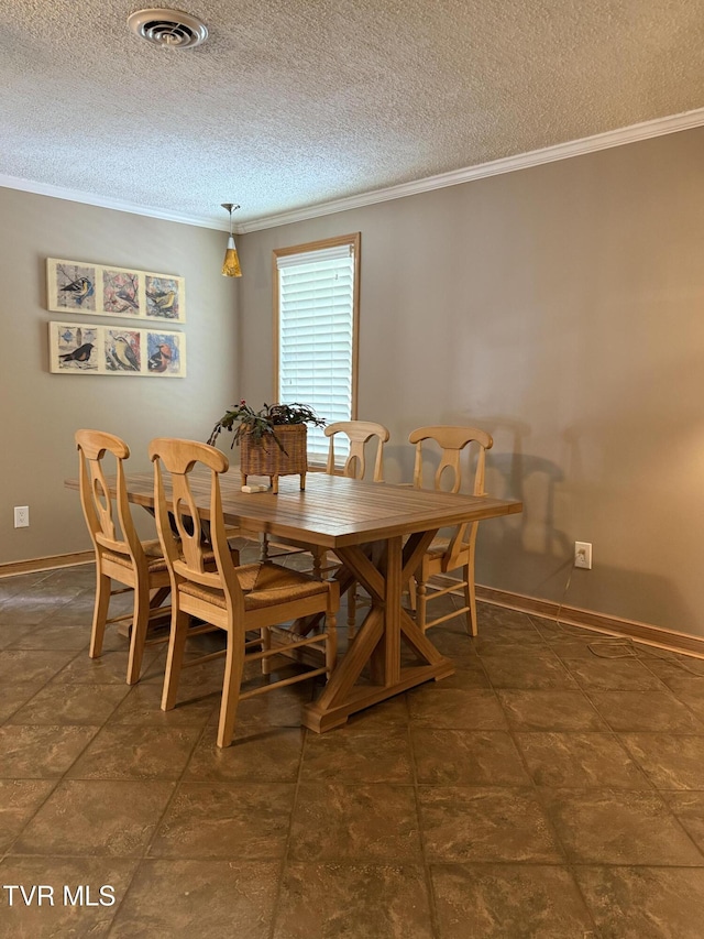 dining area with visible vents, ornamental molding, a textured ceiling, and baseboards
