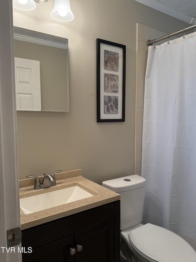 full bathroom with vanity, ornamental molding, curtained shower, and toilet