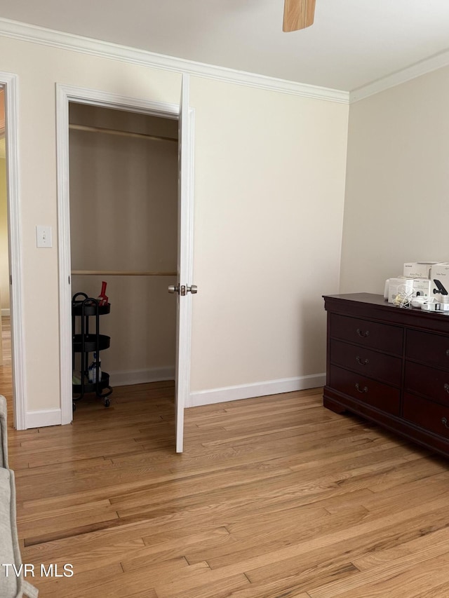 bedroom featuring baseboards, ornamental molding, and light wood-type flooring
