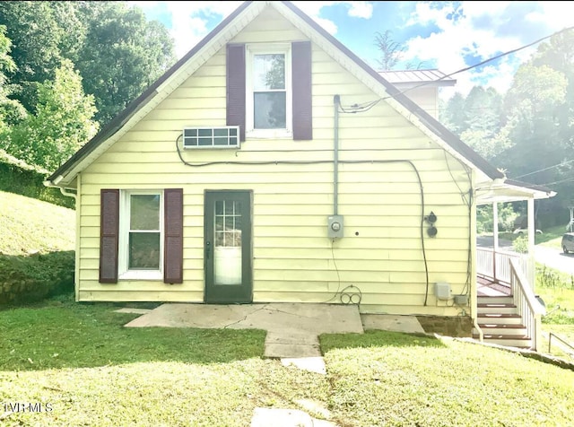 rear view of house with a lawn