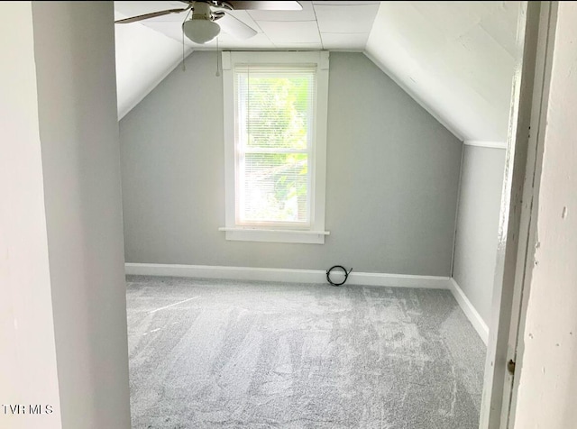 additional living space featuring baseboards, ceiling fan, carpet floors, and vaulted ceiling