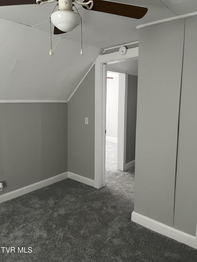 bonus room with baseboards, lofted ceiling, ceiling fan, and carpet floors