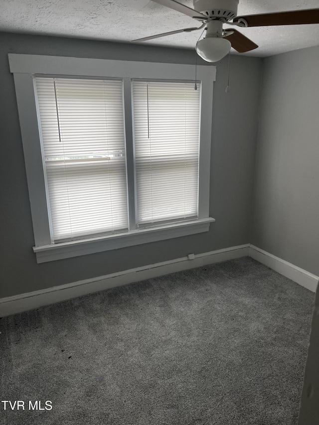 unfurnished room featuring a textured ceiling, carpet flooring, baseboards, and a ceiling fan