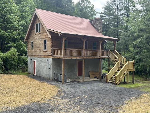 4406 Lawson Hollow Rd, Coeburn, VA 24230 - log home with a chimney, stairs, a deck, cooling unit, and a forest view