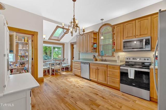 kitchen featuring a sink, open shelves, a chandelier, light wood-style floors, and appliances with stainless steel finishes