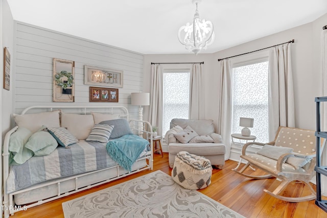 living area featuring an inviting chandelier and wood finished floors
