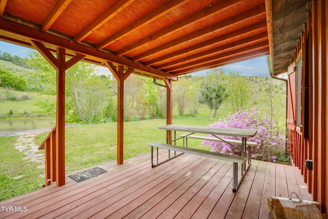 wooden deck with a lawn