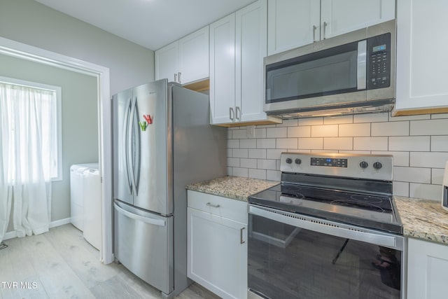 116 Weeping Willow Dr Unit 116, Abingdon, VA 24210 - kitchen featuring appliances with stainless steel finishes, tasteful backsplash, light wood-style floors, and white cabinetry