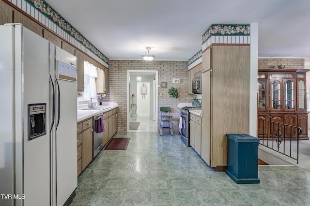 600 Valley Ave, Erwin, TN 37650 - kitchen featuring light countertops, brick wall, and appliances with stainless steel finishes
