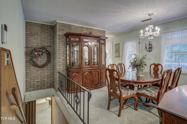 600 Valley Ave, Erwin, TN 37650 - dining space with a wealth of natural light, an inviting chandelier, and brick wall